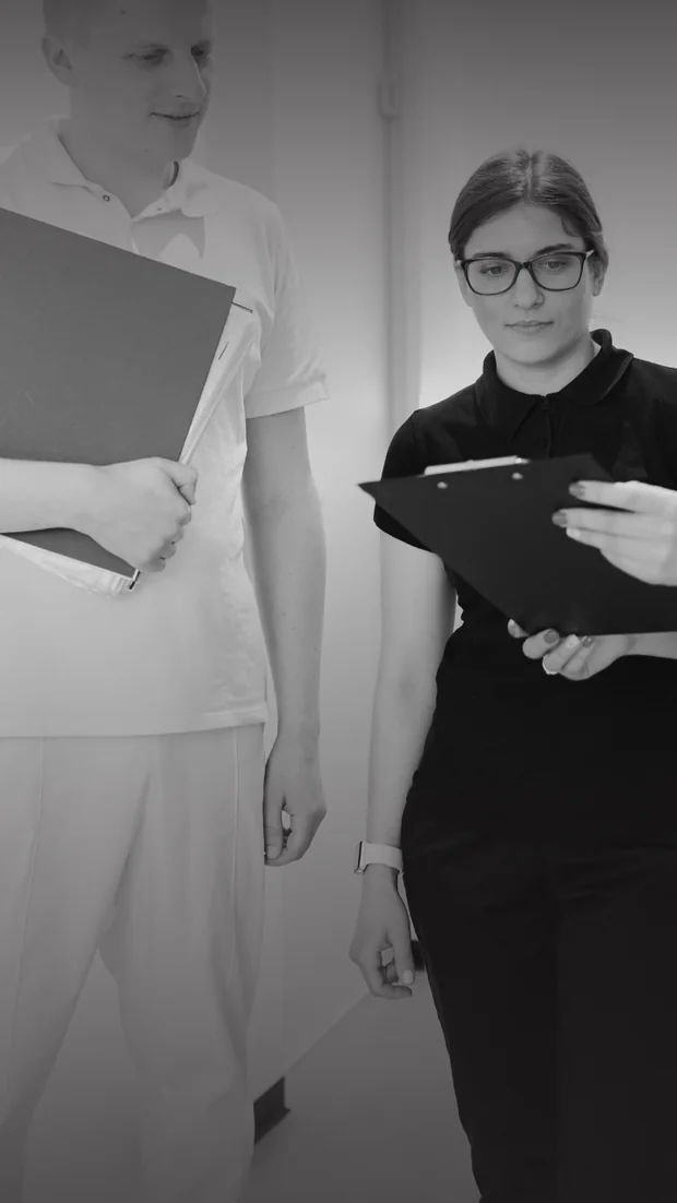 A doctor and an administrator of the ELITES clinic discussing the schedule